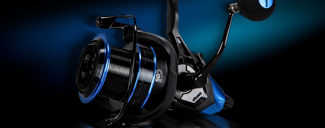 ROCKAWAY BAITFEEDER REEL - Okuma Rockaway Baitfeeder Reel-Precision machine cut brass pinion gear-Cyclonic Flow Rotor technology-Rigid metal handle design to reduce flex-Long cast, 2-tone anodized aluminum spool-On/Off auto trip baitfeeding system ROCKAWAY BAITFEEDER REEL - Okuma Rockaway Baitfeeder Reel-Precision machine cut brass pinion gear-Cyclonic Flow Rotor technology-Rigid metal handle design to reduce flex-Long cast, 2-tone anodized aluminum spool-On/Off auto trip baitfeeding system